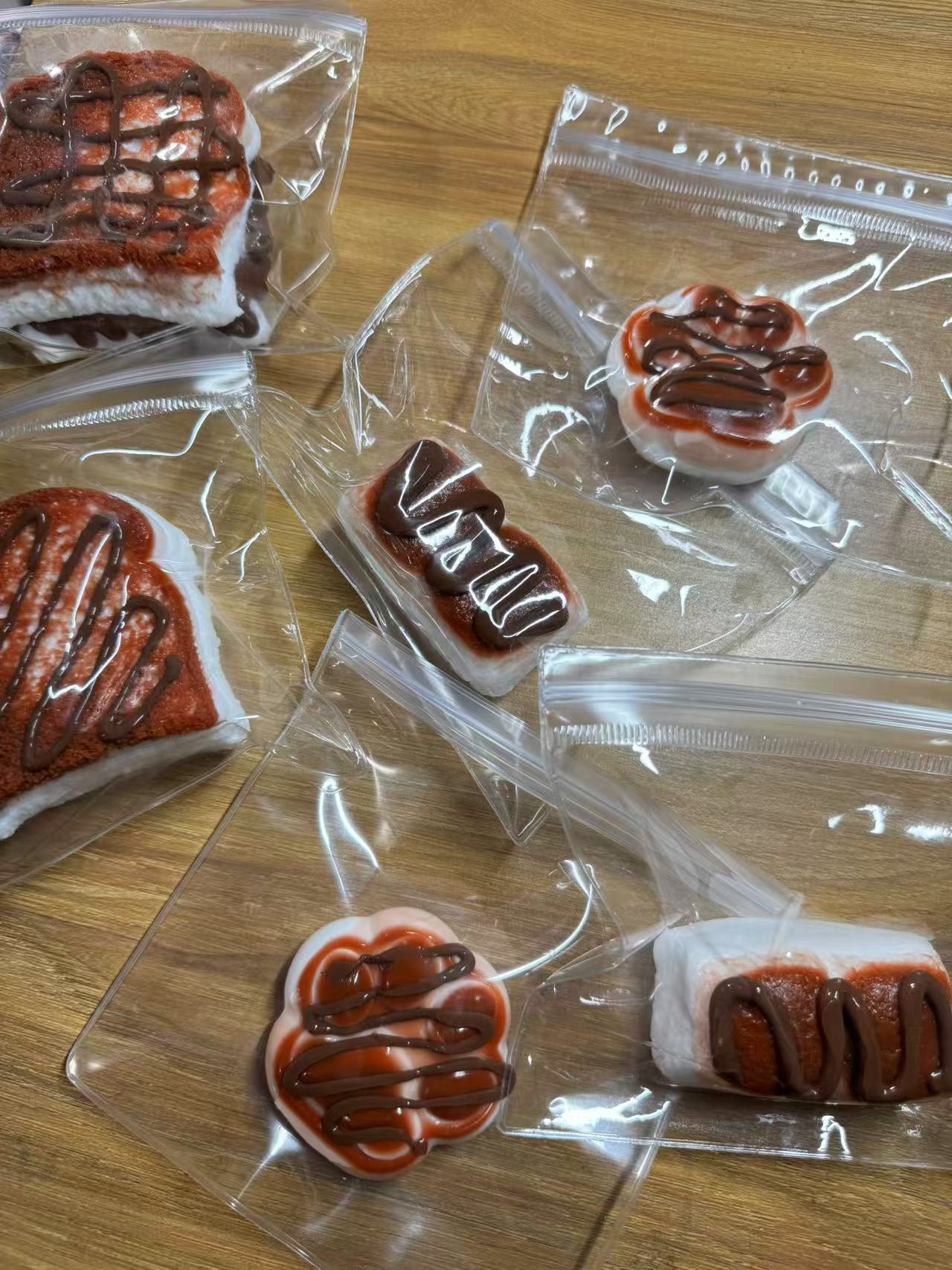 Three variations of individually packaged s'mores-shaped squeeze toys